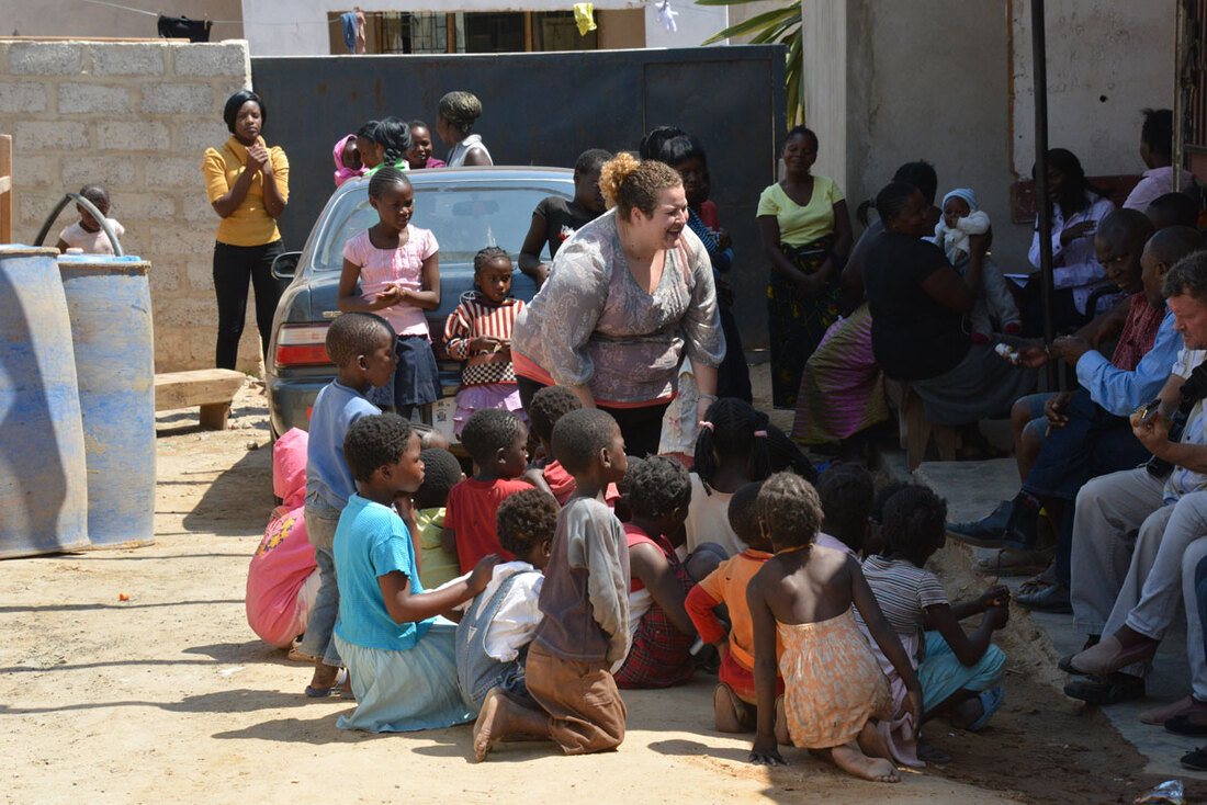 A Pure Works volunteer with children at a community clinic