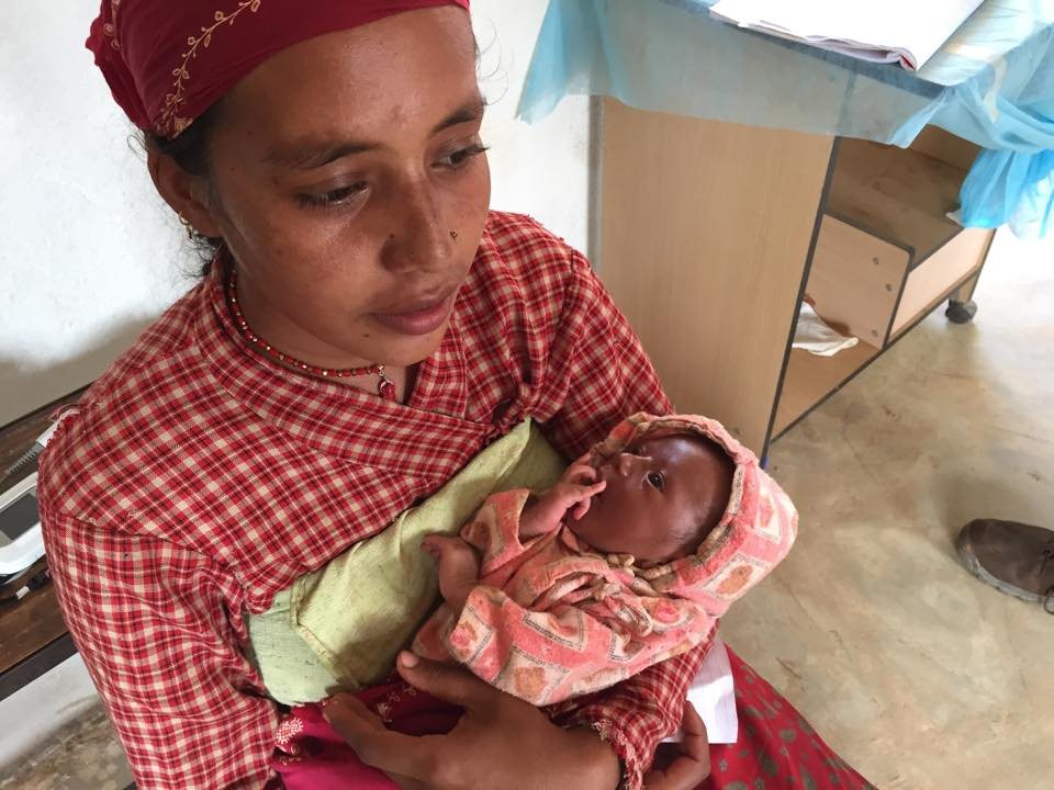A mother holding her infant