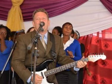 Rich Young playing guitar with a choir in Zambia, 2013