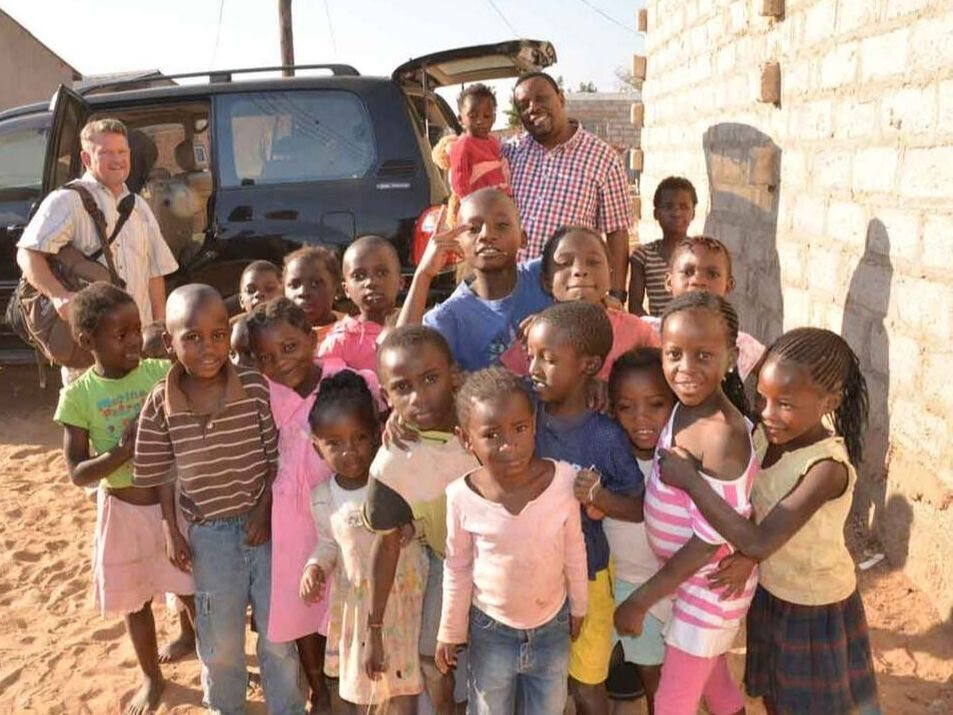 Children beside a mission vehicle in Zambia
