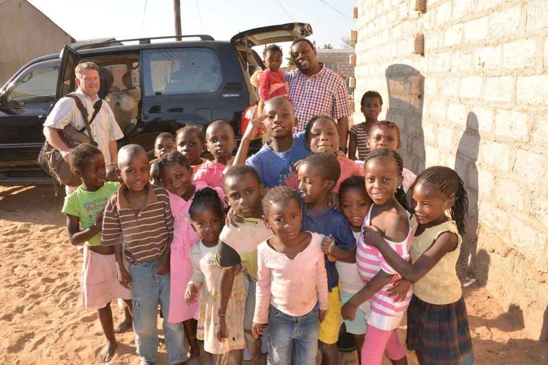 Children beside a mission vehicle in Zambia
